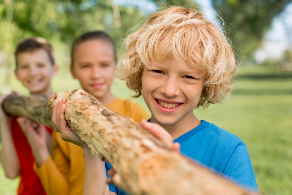 close-up-children-carrying-log-together_23-2149018930.jpg